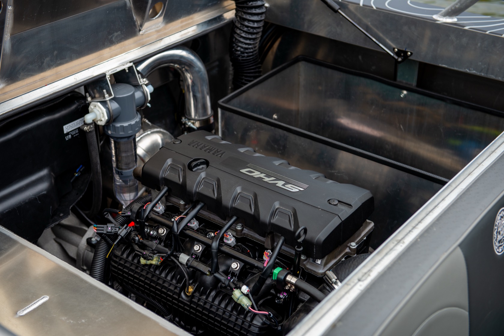 Engine bay of the jet boat showing the supercharged Yamaha SVHO marine engine