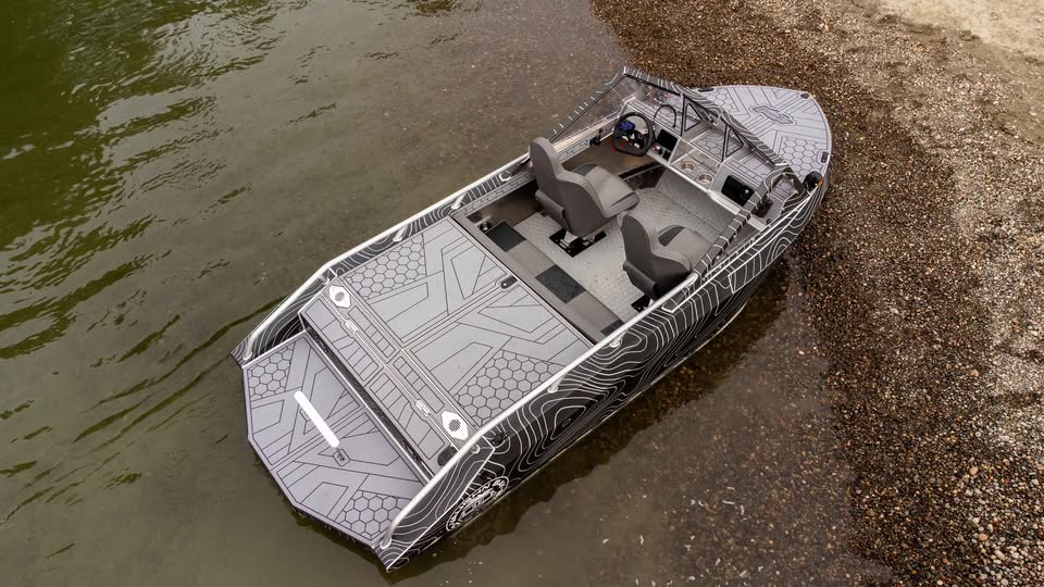 Overhead view of the VB12 show boat in shallow water, showing the two-seat cockpit, helm and open floor