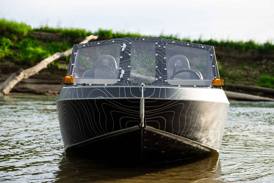 Head-on bow view of the VB12 show boat on the river showing its sharp welded entry
